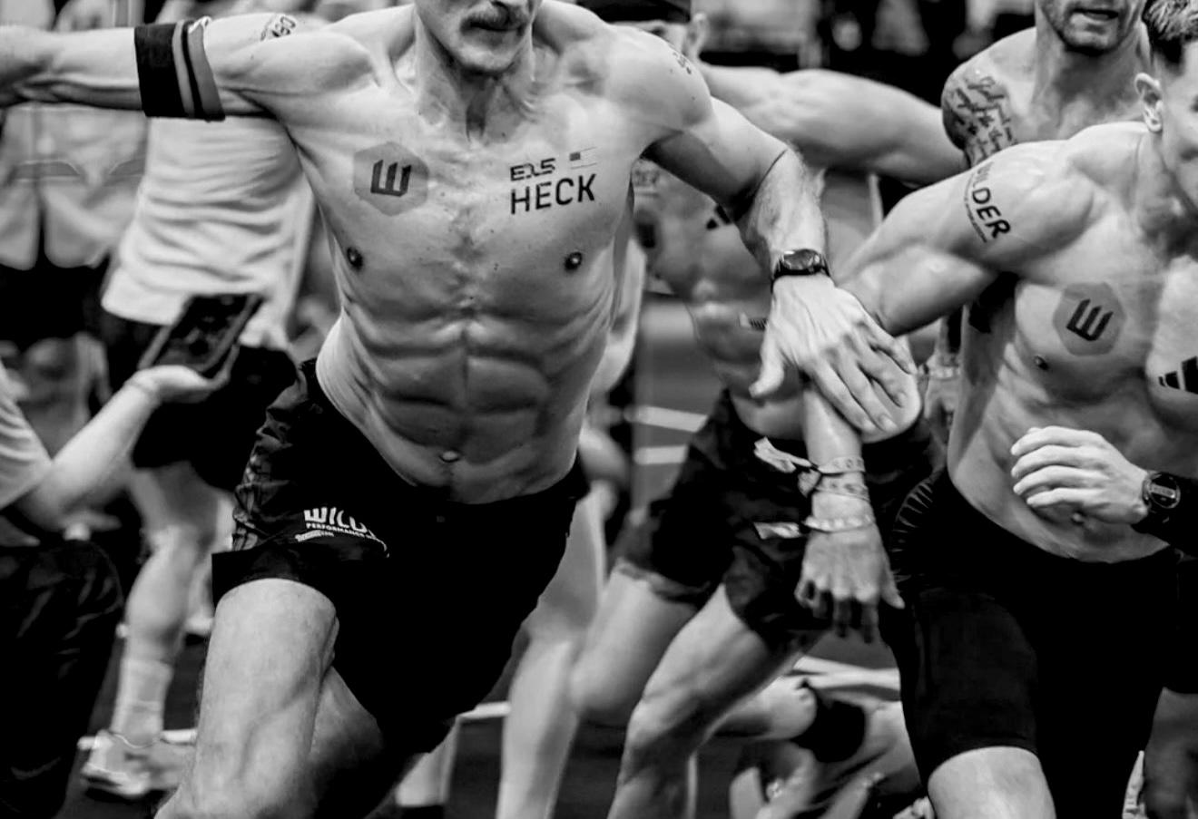 Competitors mid-race with sponsor logos applied as temporary tattoos on chest and shoulder